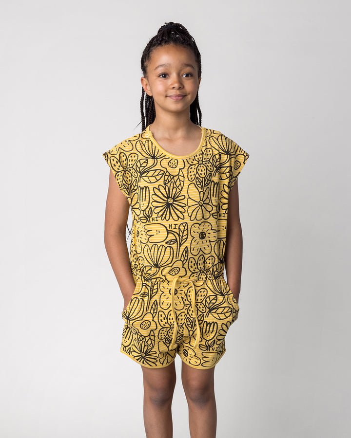 Close up of the Big Flowers Playsuit in mustard stripe on a kid, front view