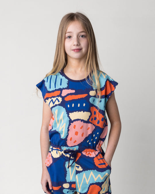 Close up of the Cool Shapes Playsuit in dark blue on a kid, front view