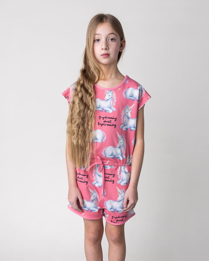 Close up of the Daydreaming Unicorn Playsuit in candy on a kid, front view