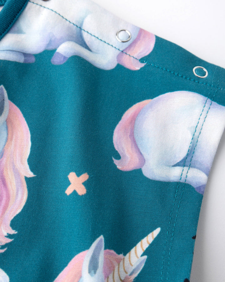 Close up of the Daydreaming Unicorn Playsuit print in teal