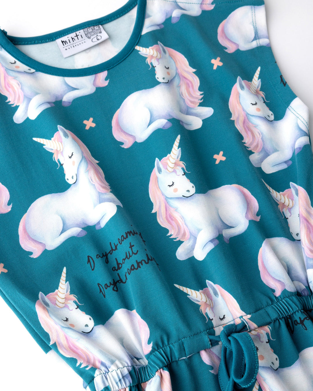 Close up of the Daydreaming Unicorn Playsuit print in teal