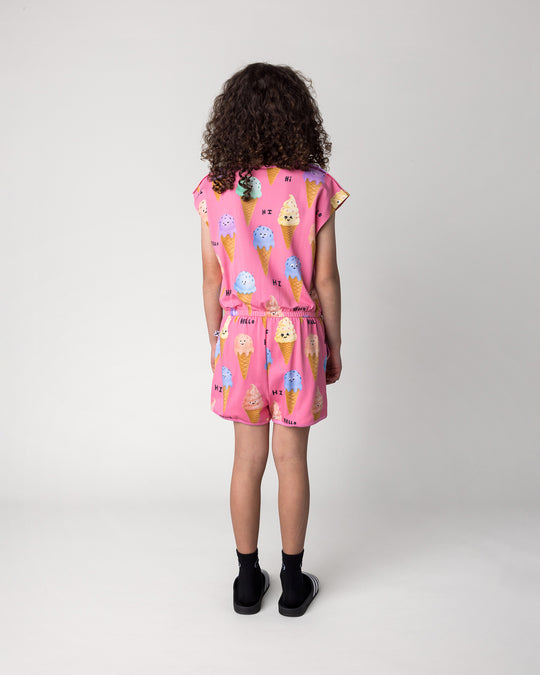 Kid wearing the Happy Icecreams Playsuit in pink, back view