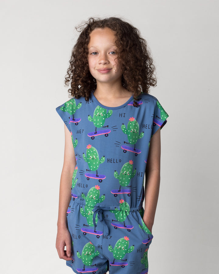 Close up of the Skate Cactus Playsuit in muted blue on a kid, front view