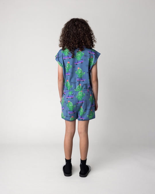 Kid wearing the Skate Cactus Playsuit in muted blue, back view