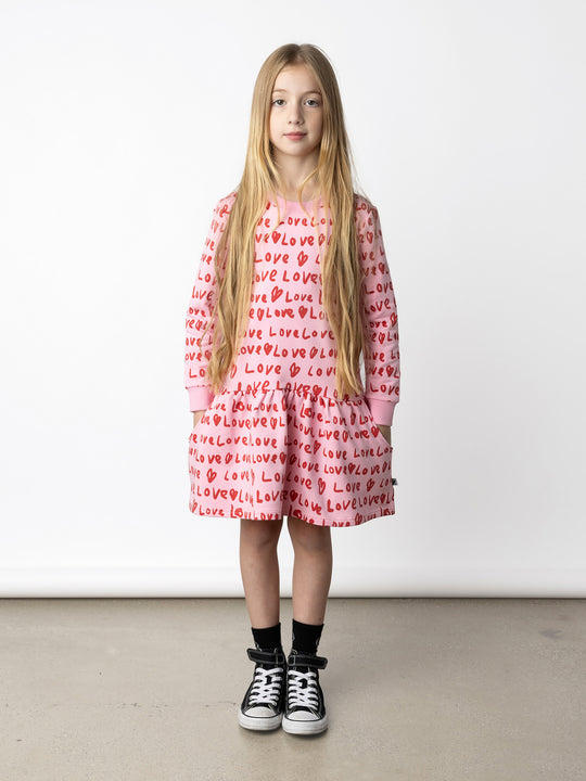 Minti kids clothing. Super cool sweatshirting weight dress with dropped skirt hem, pockets and ruching at the skirt seam. 320 Gram // 95% Cotton // 5% Elastane.