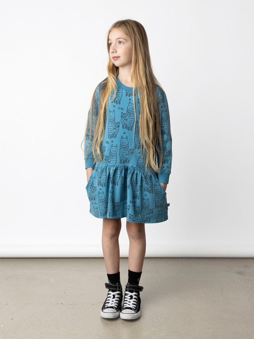 Minti kids clothing. Super cool sweatshirting weight dress with dropped skirt hem, pockets and ruching at the skirt seam. 260 Gram // 95% Cotton // 5% Elastane.