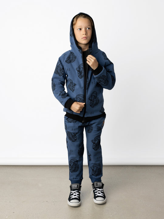 Minti kids clothing. Super cosy two-in-one Zip Up! One side is plain black with a kangaroo front pocket, the other side has our awesome Roar yardage and a contrast HI embroidery! Perfect for all occasions and super warm! 330 Gram // Brushed Inside // 95% Cotton // 5% Elastane.