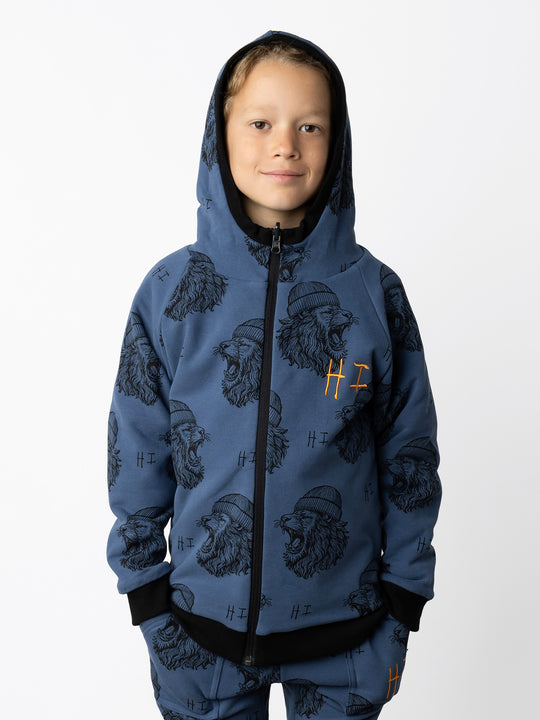 Minti kids clothing. Super cosy two-in-one Zip Up! One side is plain black with a kangaroo front pocket, the other side has our awesome Roar yardage and a contrast HI embroidery! Perfect for all occasions and super warm! 330 Gram // Brushed Inside // 95% Cotton // 5% Elastane.