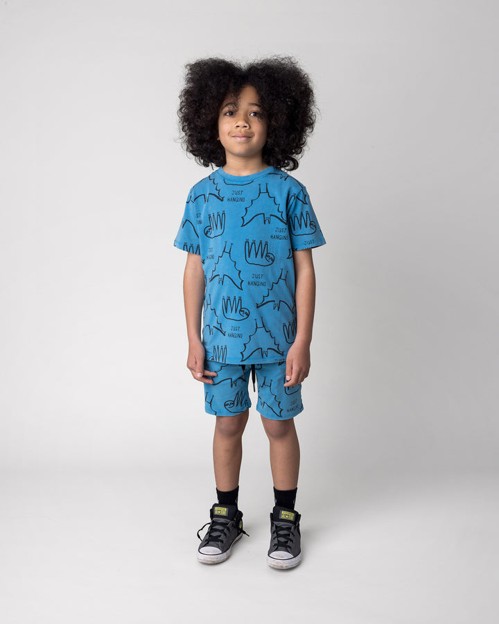 Kid wearing the Just Hanging Short in sky wash with the Just Hanging Tee in sky wash, front view