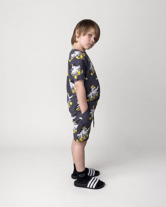 Kid wearing the Skate Ghost Short in dark grey with the Skate Ghost Tee in dark grey, side view