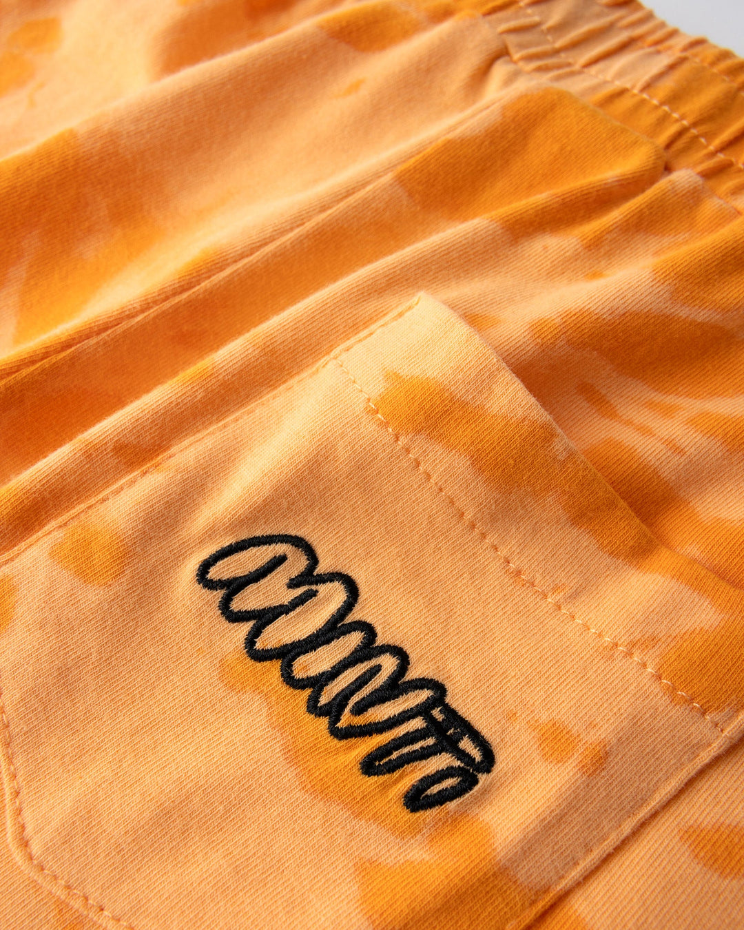Close up detail of the Splatter Short in orange