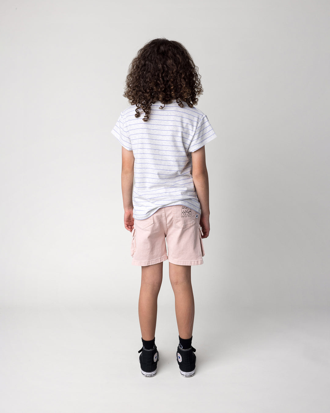 Kid wearing the Bear Hug Tee in marle and purple stripe, back view