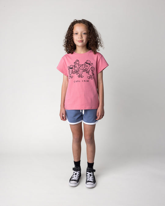 Kid wearing the Cool Crew Tee in candy with the Sprint Short in cornflower and white, front view