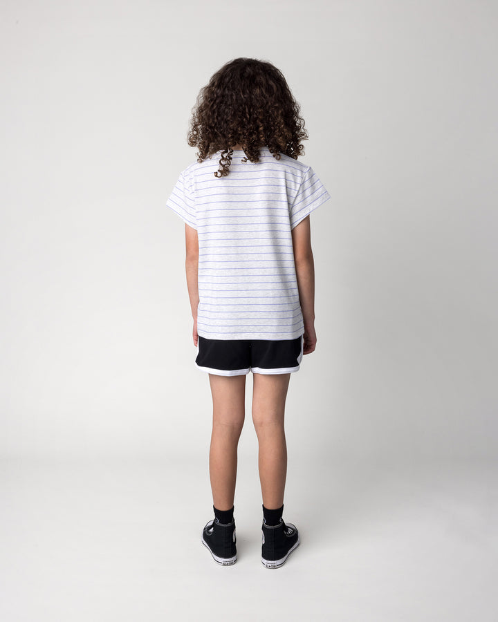Kid wearing the Chill Mates Tee in marle and purple stripe with the Sprint Short in black and white, back view