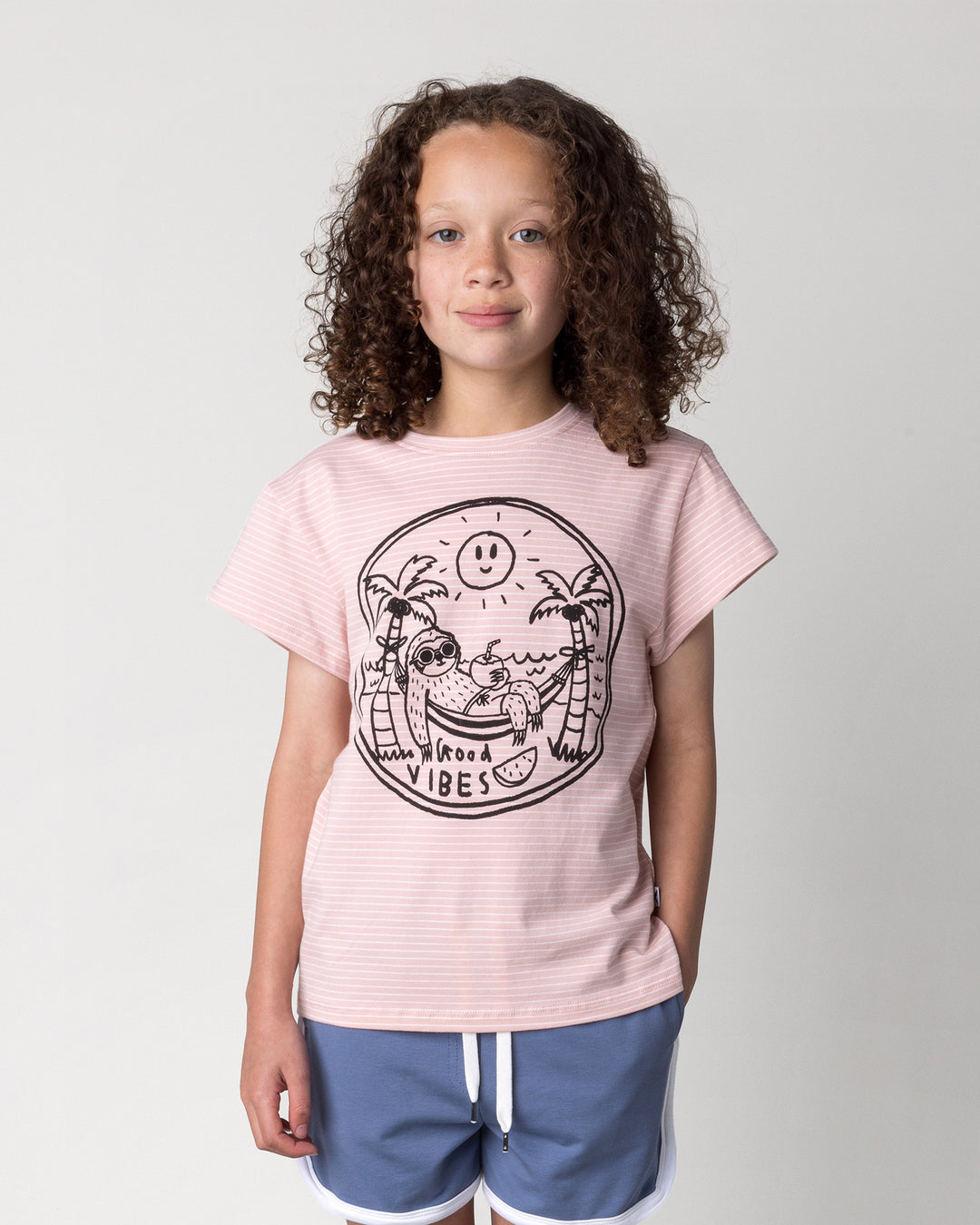 Close up of the Chill Sloth Tee in ballet stripe on a kid, front view
