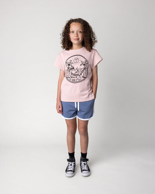 Kid wearing the Chill Sloth Tee in ballet stripe with the Sprint Short in cornflower and white, front view