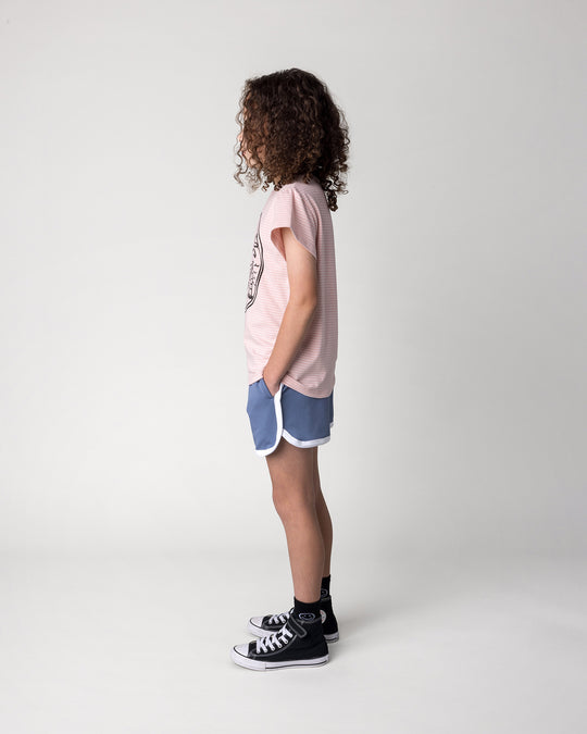 Kid wearing the Chill Sloth Tee in ballet stripe with the Sprint Short in cornflower and white, side view
