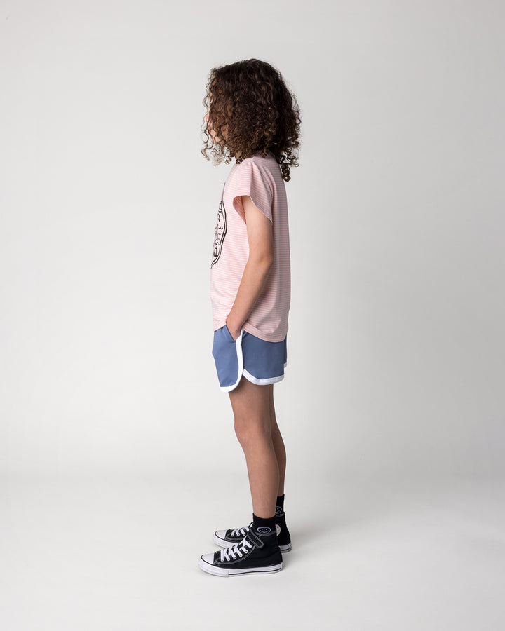 Kid wearing the Chill Sloth Tee in ballet stripe with the Sprint Short in cornflower and white, side view