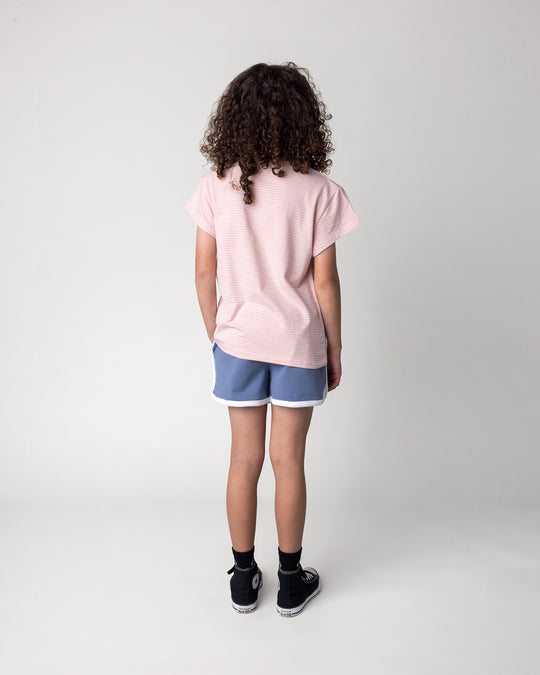 Kid wearing the Chill Sloth Tee in ballet stripe with the Sprint Short in cornflower and white, back view