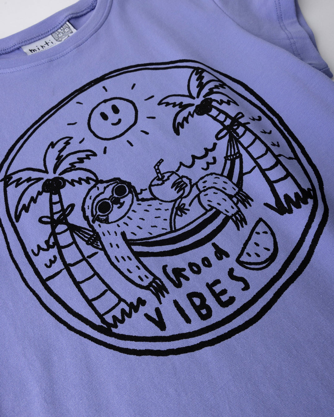 Close up of the Chill Sloth Tee print in purple