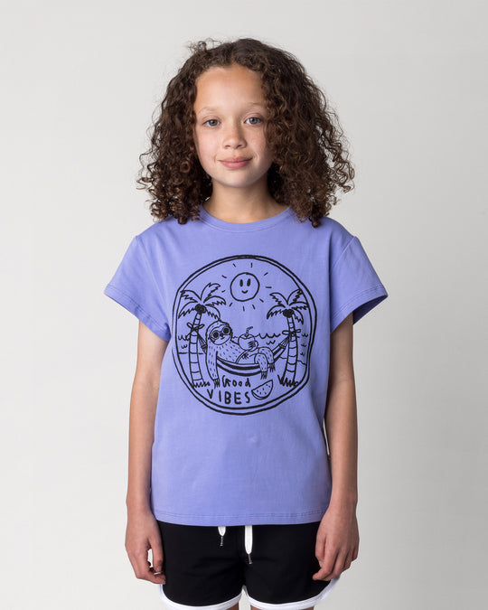 Close up of the Chill Sloth Tee in purple on a kid, front view