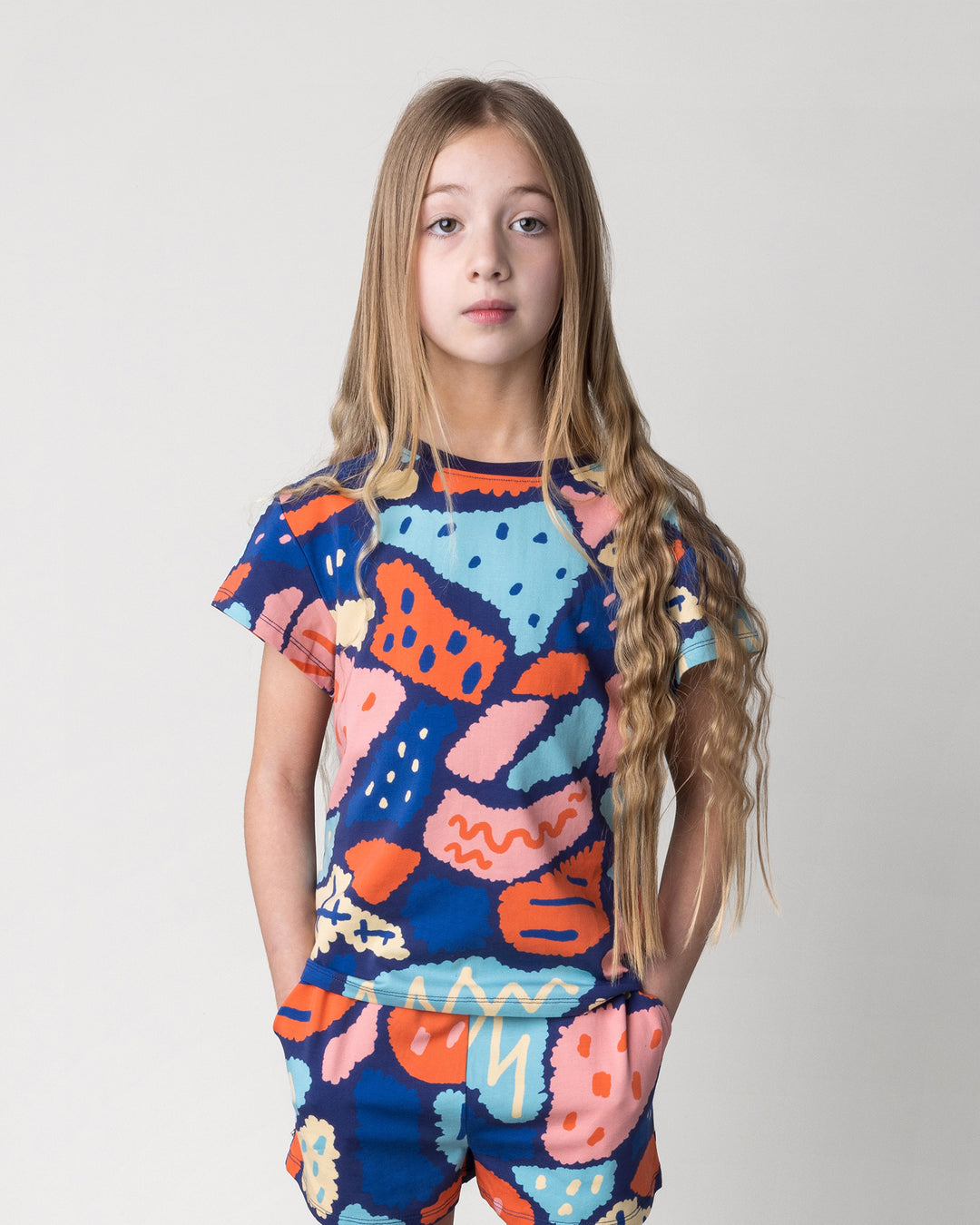 Close up of the Cool Shapes Tee in dark blue on a kid, front view
