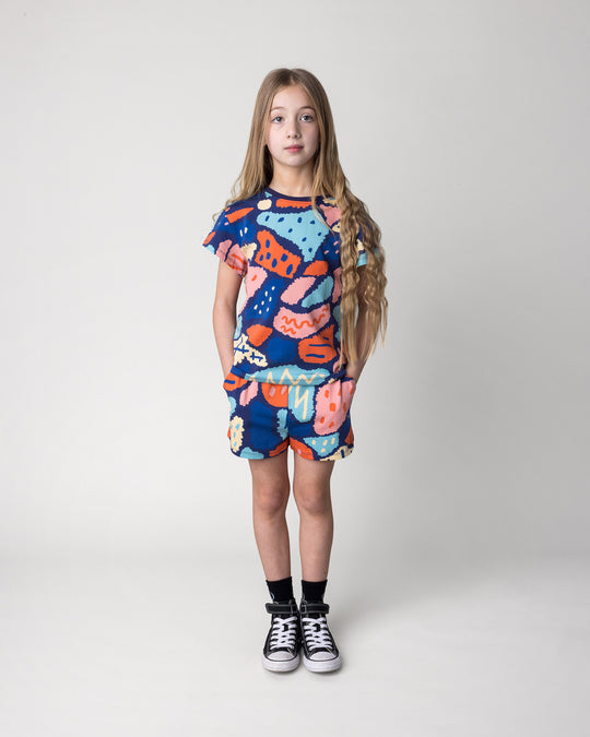 Kid wearing the Cool Shapes Tee in dark blue with the Cool Shapes Short in dark blue, front view