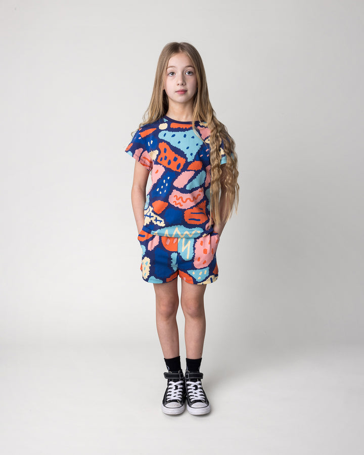 Kid wearing the Cool Shapes Tee in dark blue with the Cool Shapes Short in dark blue, front view