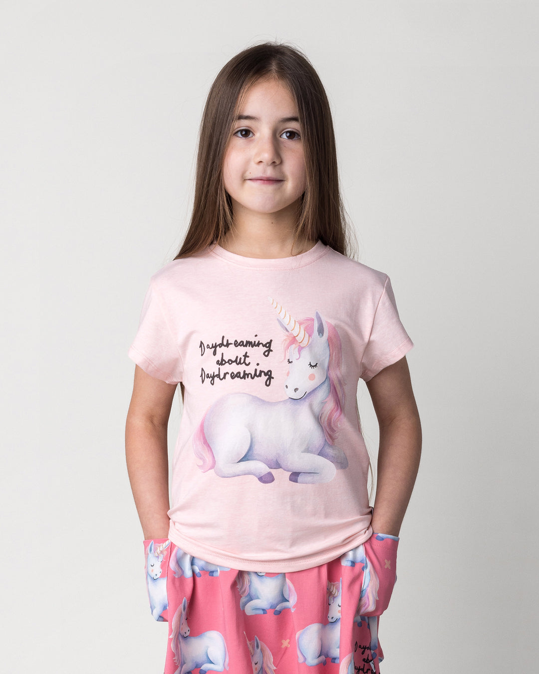 Close up of the Daydreaming Unicorn Tee in pink marle on a kid, front view