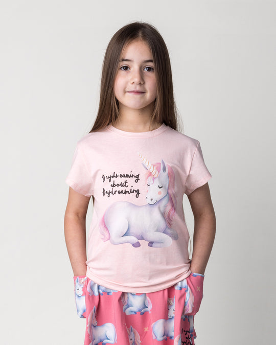 Close up of the Daydreaming Unicorn Tee in pink marle on a kid, front view