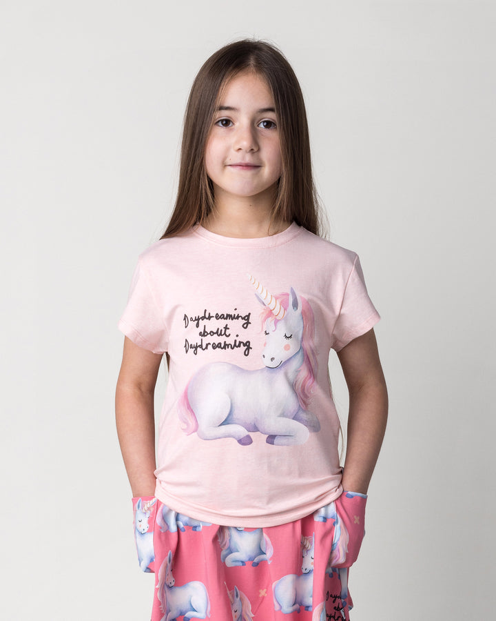 Close up of the Daydreaming Unicorn Tee in pink marle on a kid, front view