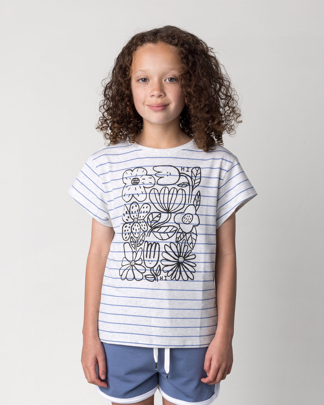 Close up of the Flower Party Tee in marle and blue stripe on a kid, front view