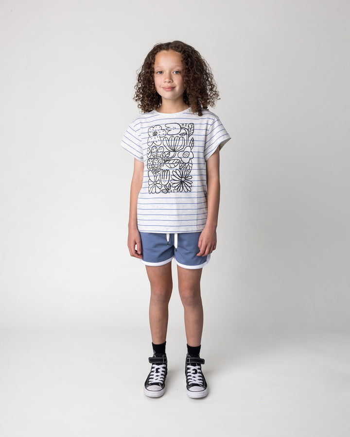 Kid wearing the Flower Party Tee in marle and blue stripe with the Sprint Short in cornflower and white, front view