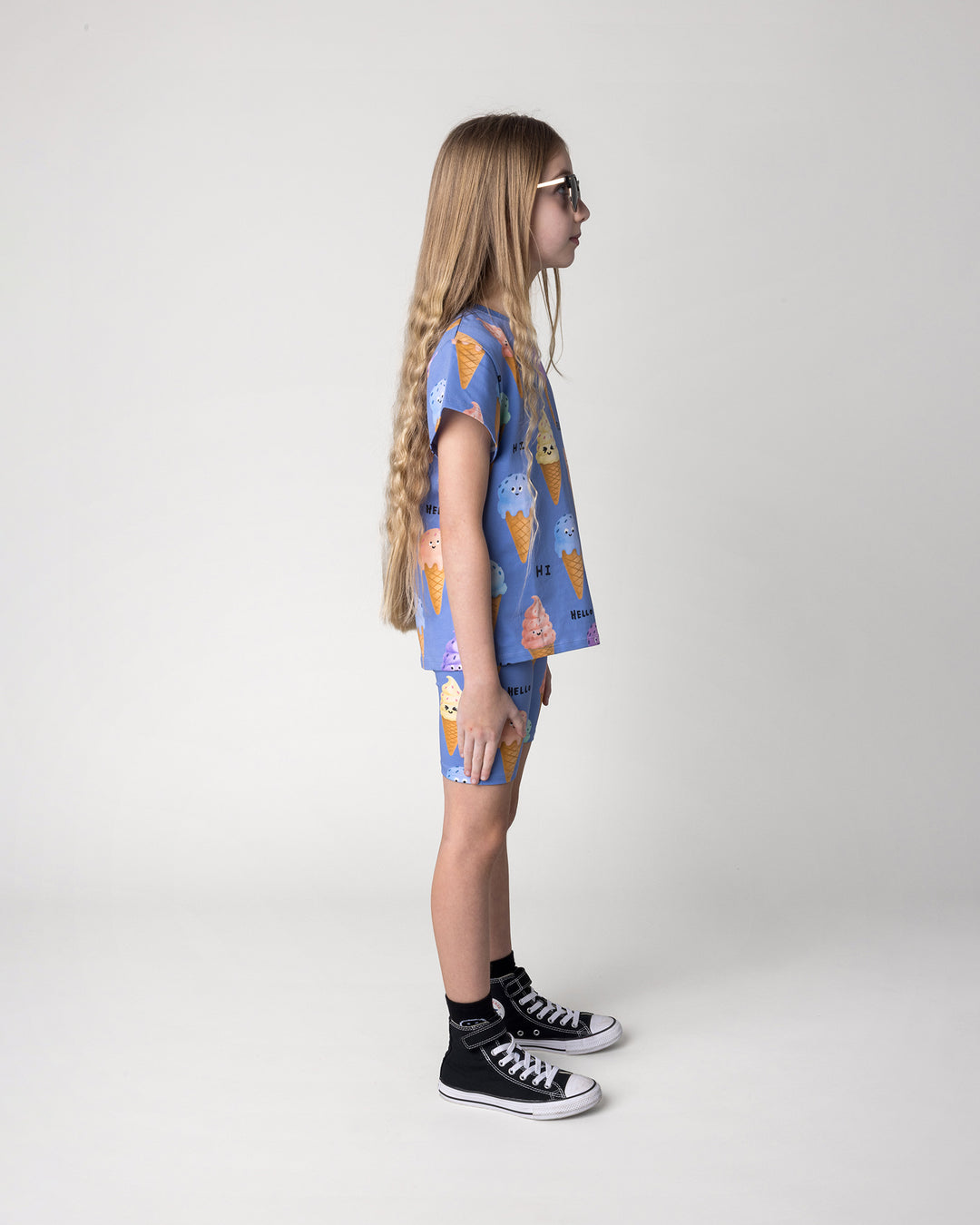 Kid wearing the Happy Icecreams Tee in cornflower with the Happy Icecreams Bike Pant in cornflower, side view