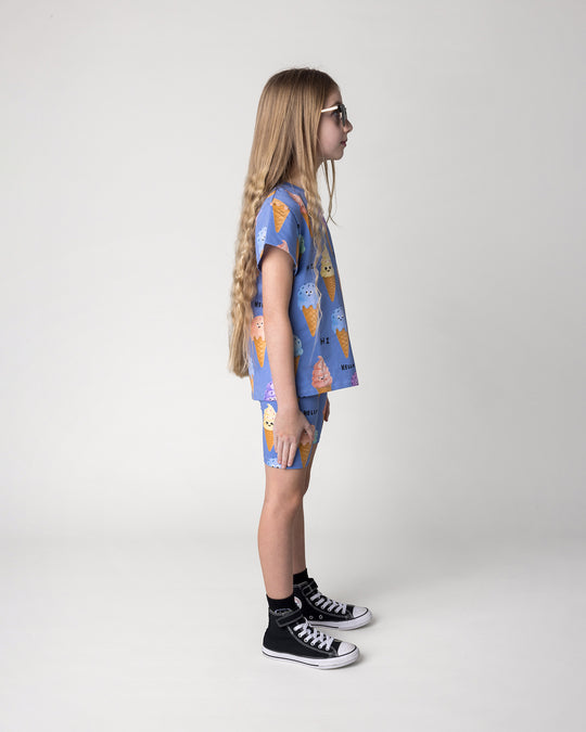 Kid wearing the Happy Icecreams Tee in cornflower with the Happy Icecreams Bike Pant in cornflower, side view