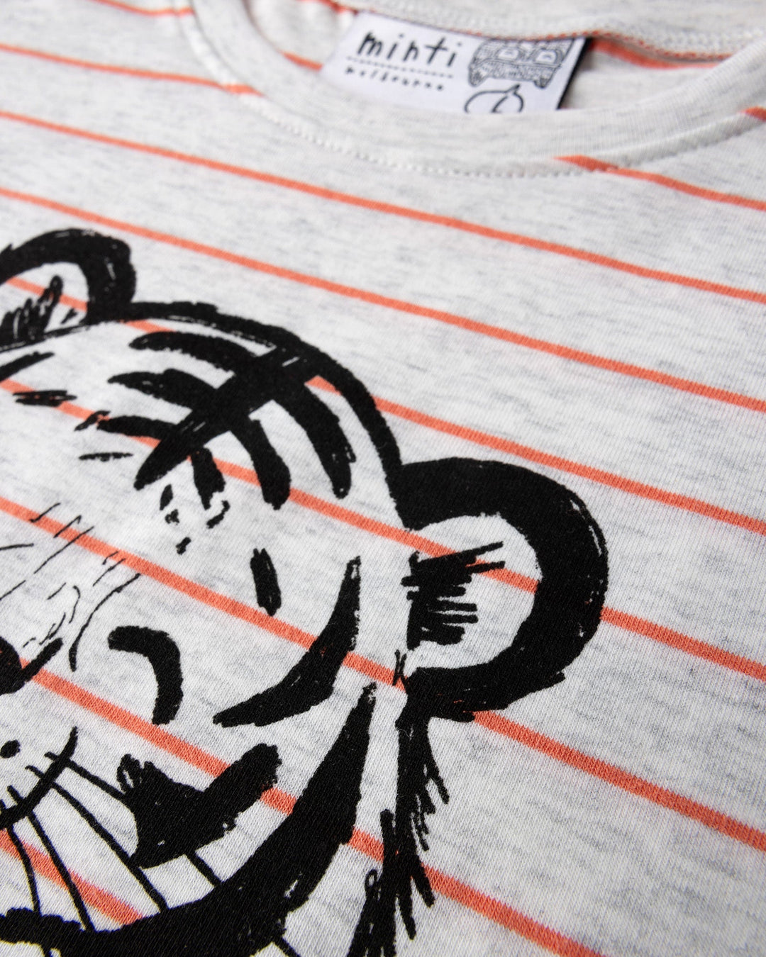 Close up of the Happy Tiger Tee print in marle and coral stripe