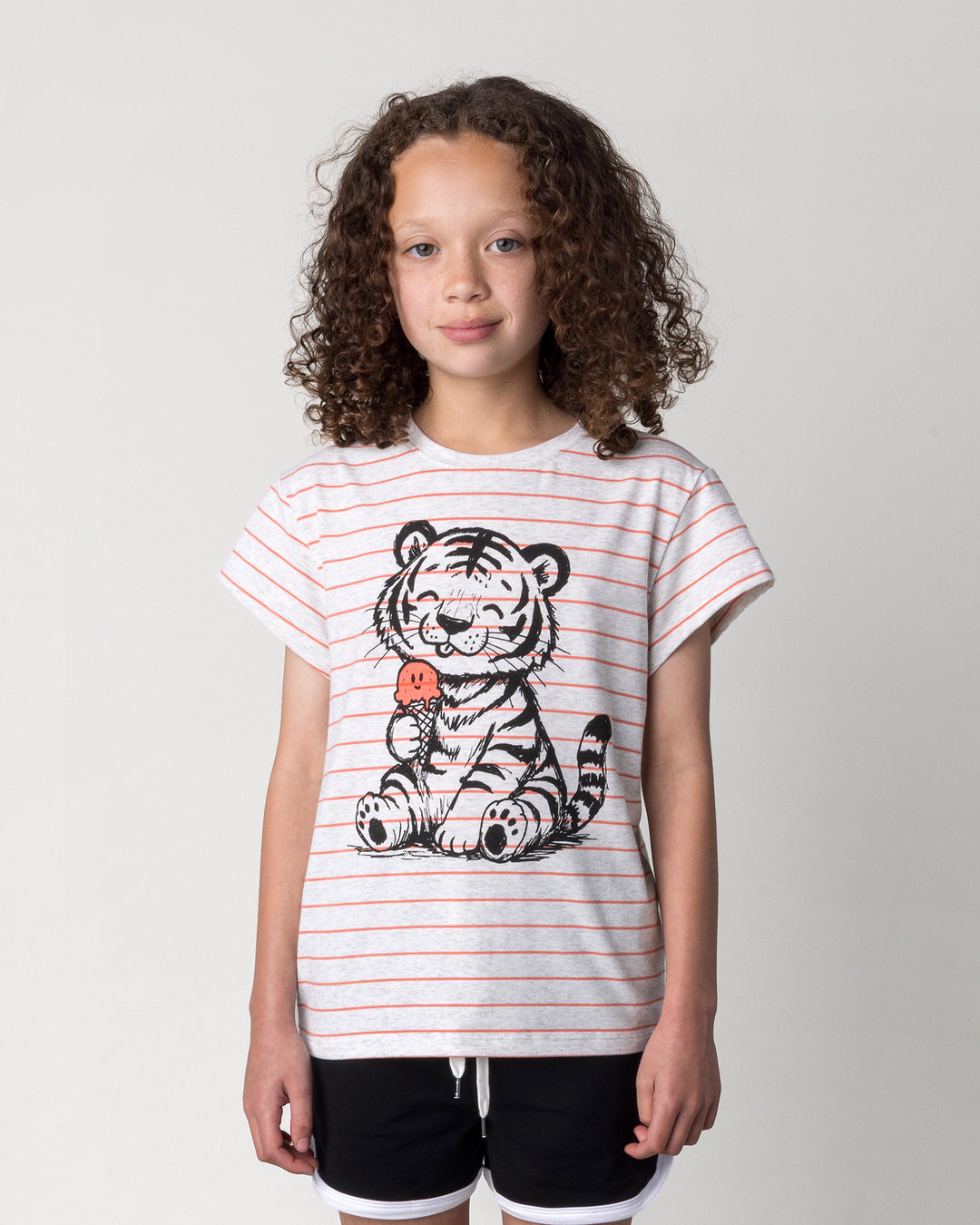 Close up of the Happy Tiger Tee in marle and coral stripe on a kid, front view