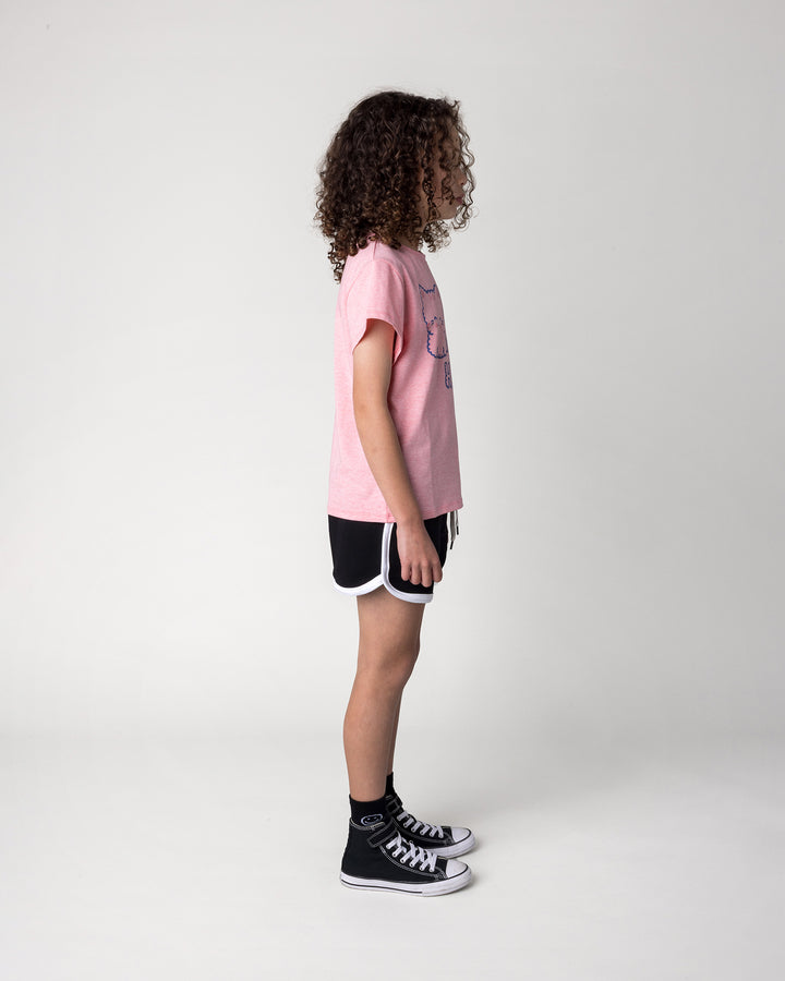 Kid wearing the Hi Cat Bear Tee in strawberry marle with the Sprint Short in black and white, side view
