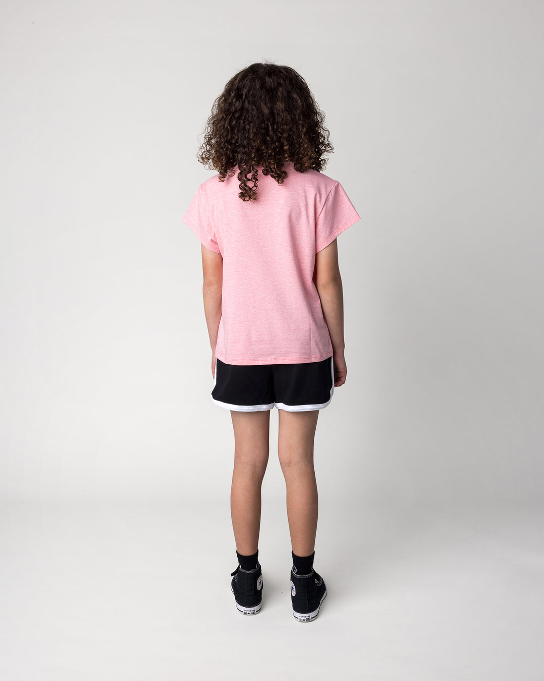 Kid wearing the Hi Cat Bear Tee in strawberry marle with the Sprint Short in black and white, back view