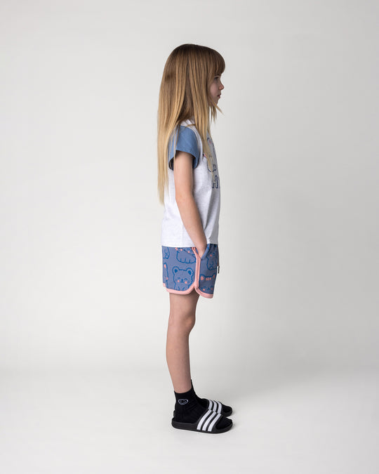 Kid wearing the Hi Cat Bear Tee in white marle, blue and pink with the Hi Cat Bear Short in cornflower and pink, side view