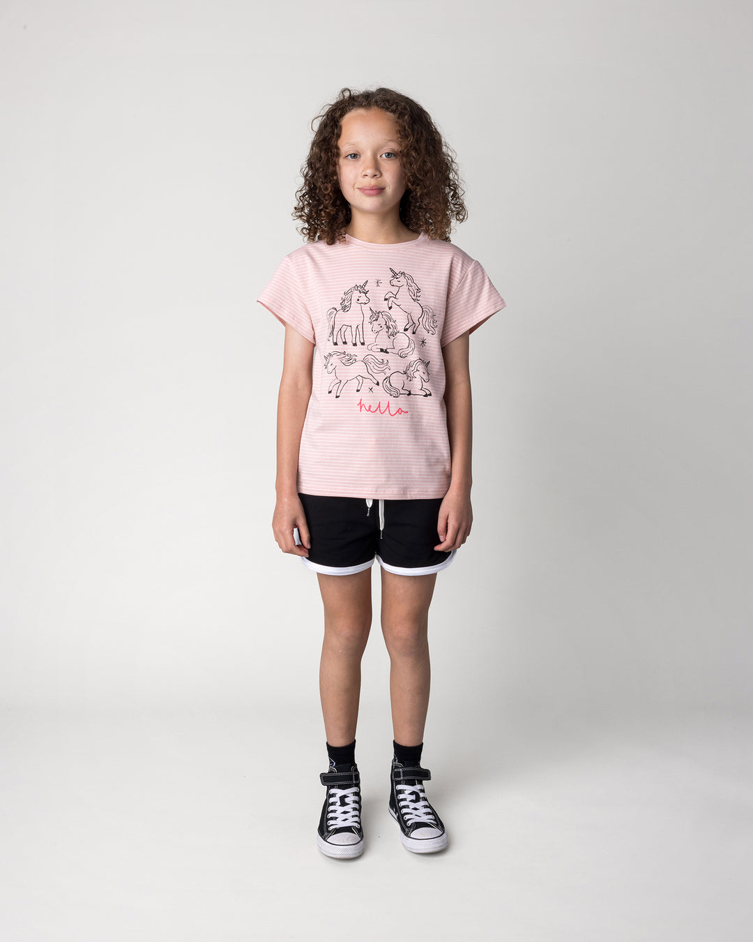 Kid wearing the Hello Unicorns Tee in ballet stripe with the Sprint Short in black and white, front view