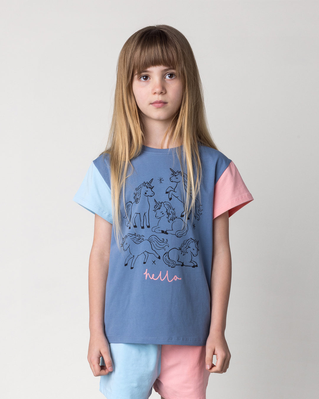 Close up of the Hello Unicorns Tee in mid blue, light blue and pink on a kid, front view