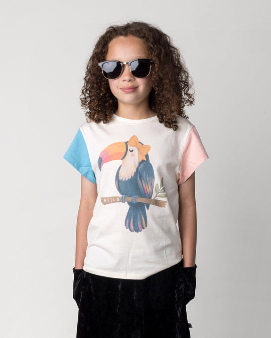 Close up of the Hello Toucan Tee in cream, pink and aqua on a kid, front view