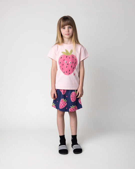 Kid wearing the Happy Strawberry Tee in pink marle with the Happy Strawberry Skirt in turquoise, front view