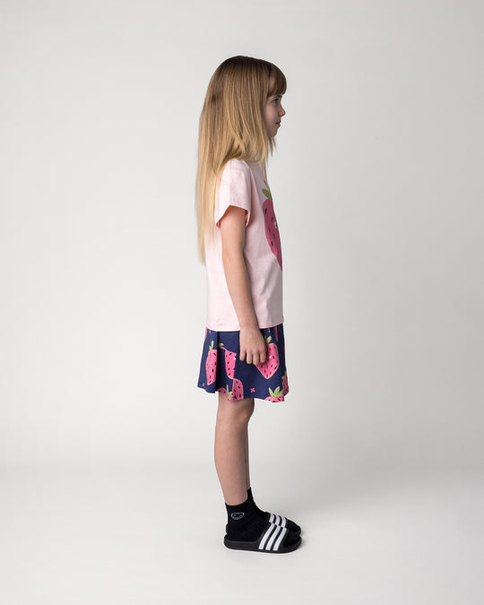 Kid wearing the Happy Strawberry Tee in pink marle with the Happy Strawberry Skirt in turquoise, side view