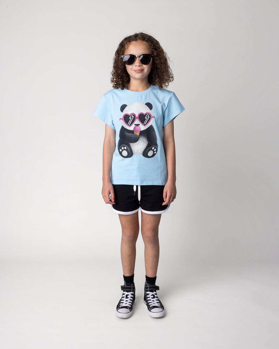 Kid wearing the Icecream Panda Tee in light blue with the Sprint Short in black and white, front view