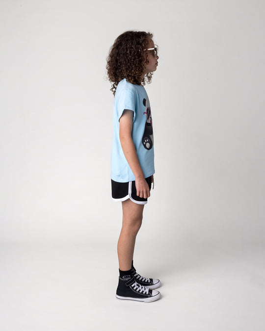 Kid wearing the Icecream Panda Tee in light blue with the Sprint Short in black and white, side view