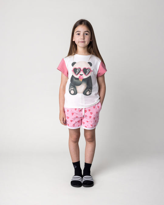 Kid wearing the Icecream Panda Tee in white and candy with the Hearts Short in pink and white, front view