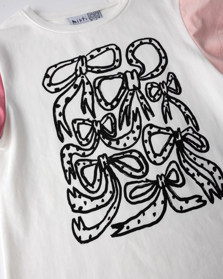 Close up of the Messy Bows Tee print in white and pinks