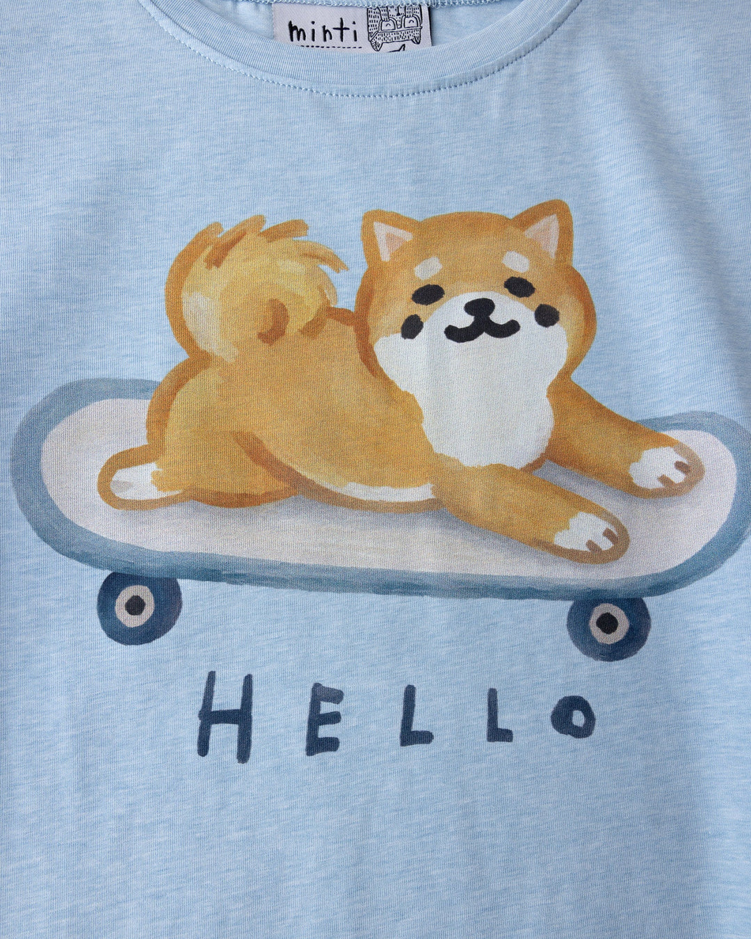 Close up of the Skate Puppy Tee print in light blue marle
